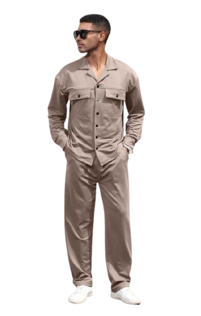 Man in beige utility outfit and sunglasses standing on steps near white columns.